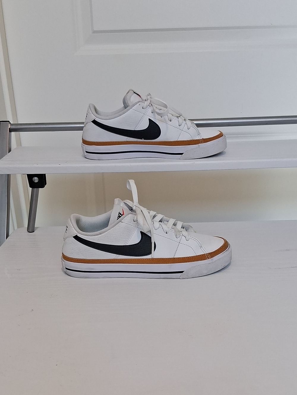 Nike White Low-Top Sneakers with Black Swoosh and Brown Trim